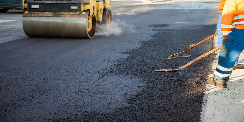 Asphalt roller compacting new pavement